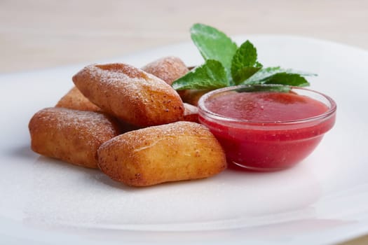 Curd bars with strawberry jam decorated with mint leaf.
