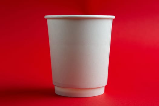 cardboard cup without lid on red background
