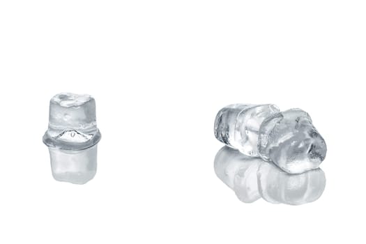 Piece of ice cubes melting on white glass table