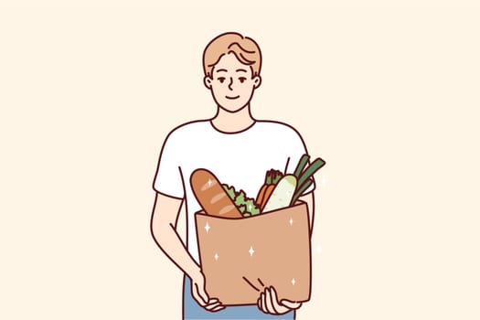 Portrait of smiling young man with bag with groceries. Happy guy holding package with goods and products. Shopping and nutrition. Vector illustration.