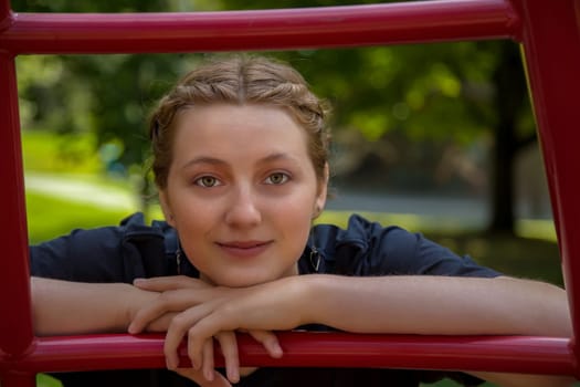 blonde woman at the park posing in red ladder amusement playground youth girl lifestyle enjoyment