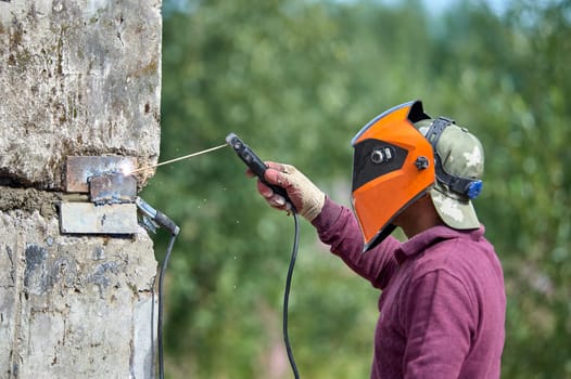 The welder welds reinforced concrete products together. High quality photo