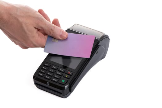 Attached plastic card to the payment terminal with a man's hand on a white isolated background, copy space. High quality photo