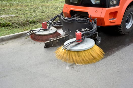 A special machine sweeps city paths. High quality photo