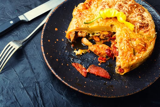 Mexican pie with smoked sausage and chicken. Meat pie.Space for text