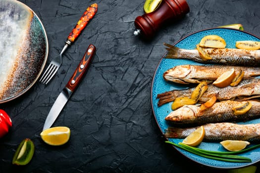 Delicious baked pelengas, fish with kiwi and lime.