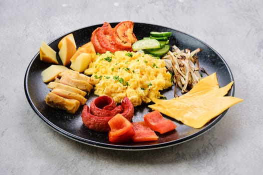 Scrambled eggs with various sausages, cheddar cheese, bell pepper and roasted onion