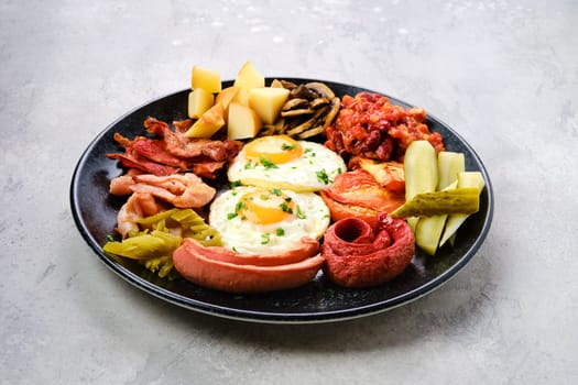 Brekfast plate. Fried egg, sausage, champignon, bacon, bean ragout, ham, cheddar, tomato and bell pepper