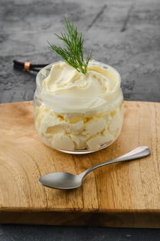 Closeup view of fat sour cream in a glass pot