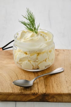 Closeup view of fat sour cream in a glass pot
