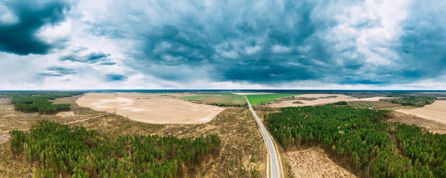 Aerial View Of Highway Road Through Deforestation Area Landscape. Green Pine Forest In Deforestation Zone. Top View Of Field And Forest Landscape. Drone View. Bird's Eye View