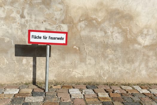 Sign at an access road for the fire department in the city center of Wittenberg in Germany. Translation: area for the fire brigade