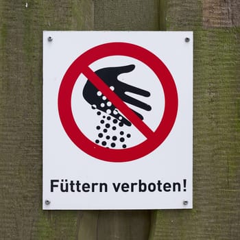 Sign with the inscription feeding prohibited on the fence in a zoo in Germany