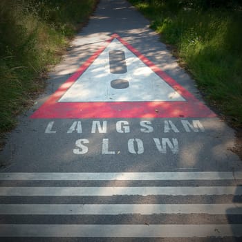 Request to drive slowly on a narrow asphalt road in Austria