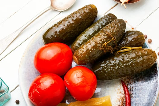 Homemade pickled cucumbers and tomatoes, homemade pickles. White background