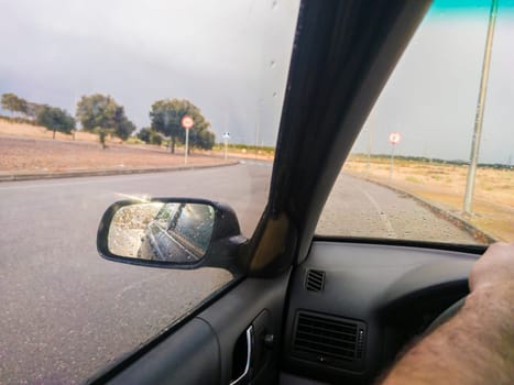 Driving through a roundabout in rainy weather. Tire grip concept