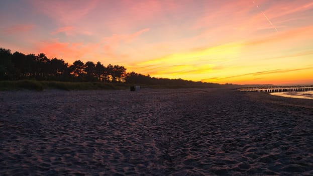 sunset on the beach of the baltic sea in zingst. warm light atmosphere. resort