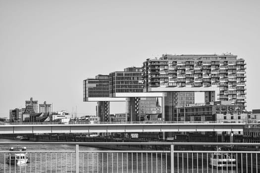 Crane house in black and white shot, in Cologne, Germany. Modern architecture at the port of the river Rhine. In the background the center of the city center. Architecture shot from big city Cologne.