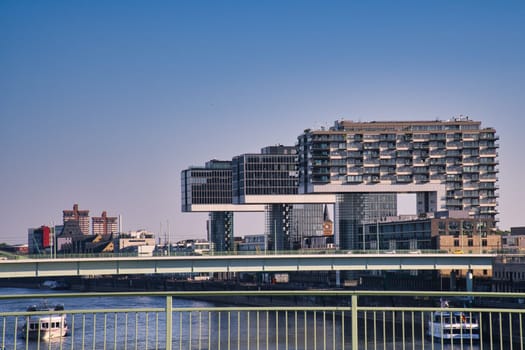 Crane house in cologne, germany. Modern architecture at the port of the river Rhine. In the background the center of the city center. Architecture shot from big city Cologne.