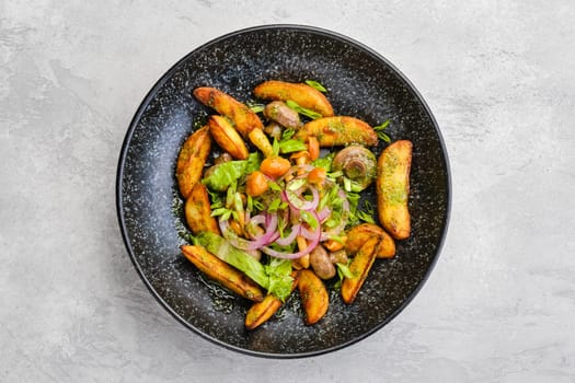 Top view of fried potato wedges with champignons dressed with red and white onion