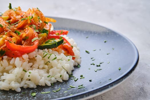 Closeup view of pulled beef with steamed bell pepper, zucchini and boiled rice