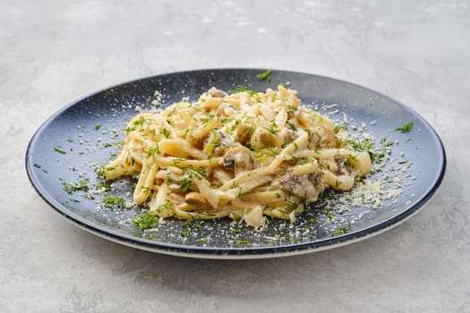 Pasta with honey agarics, onion and cheese on a plate
