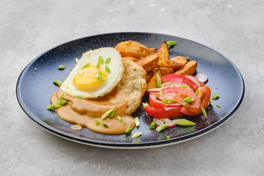 Chopped pork sirloin with fried potato wedges, egg, fresh tomato and radish