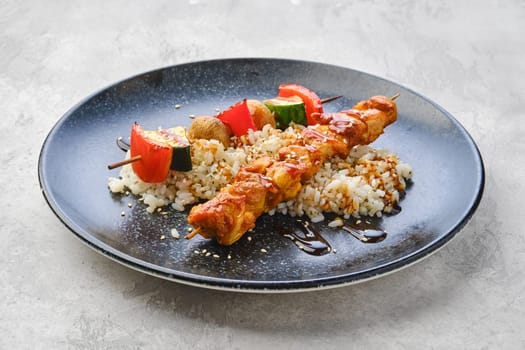 Shashlik with chicken and grilled champignon with bell pepper and zucchini served with boiled rice