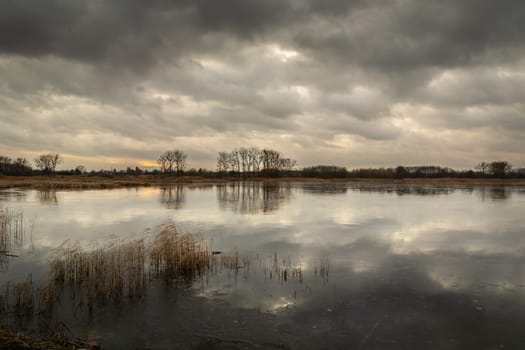 Dark clouds over the frozen lake, Stankow, Poland