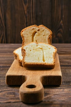Closeup view of fresh biscuit cake with apple on wooden table
