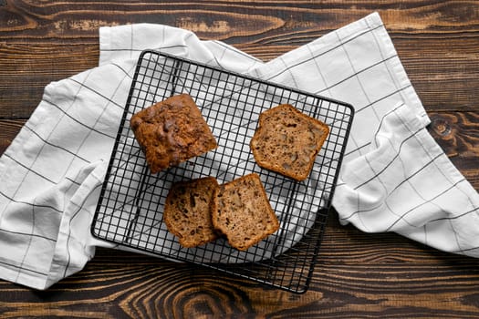 Overhead view of biscuit cake with walnut on baking grid