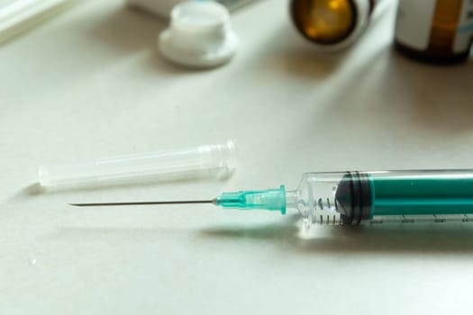 Closeup of a syringe with a long needle on the countertop