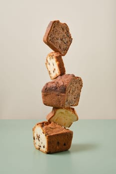 Stacked pieces of biscuit cupcakes. Balancing cakes.