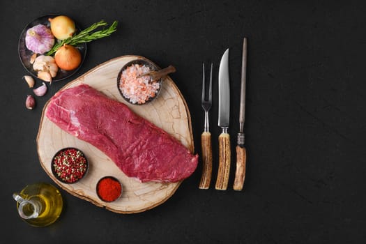 Overhead view of raw beef tri-tip roast with spice and seasoning ready for cooking