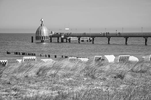 on the coast of the baltic sea on zingst. the pier and the groynes that reach into the water. beautiful light atmosphere in a romantic place