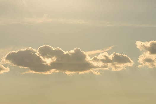 Clouds illuminated by the sun in the sky as background. Background image for further editing
