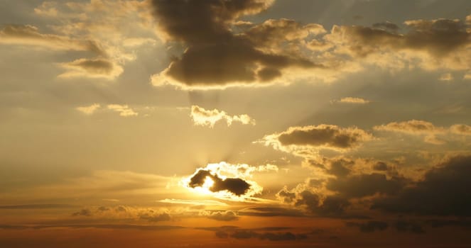Clouds illuminated by the sun in the sky as background. Background image for further editing