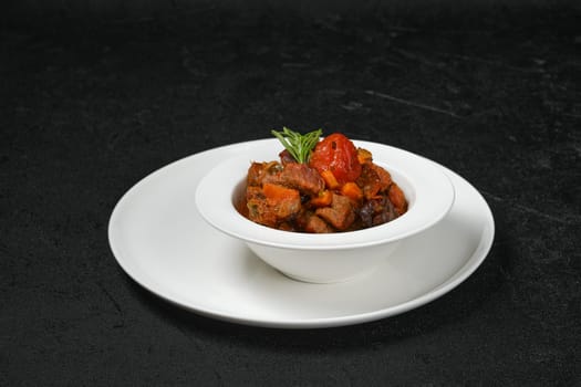 Beef stew with tomato on a plate