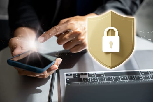 Security networks. Business man people pointing finger to screen of mobile phone, 3D golden shield with lock icon for futuristic technology cyber protection from privacy on laptop computer