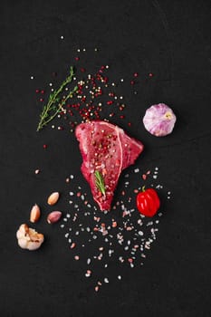 Overhead view of raw chuck eye steak with ingredients for cooking