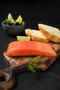 Piece of fresh salmon steak with ciabatta and spicy herb sauce
