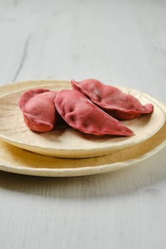 Concept of delivery of semifinished food. Sweet dumplings stuffed with cherry and frozen.