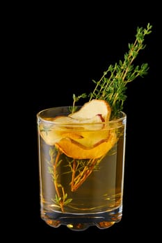 Hot apple winter drink with thyme and ginger isolated on black