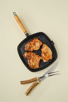 Overhead view of fried chopped pork tenderloin on frying pan