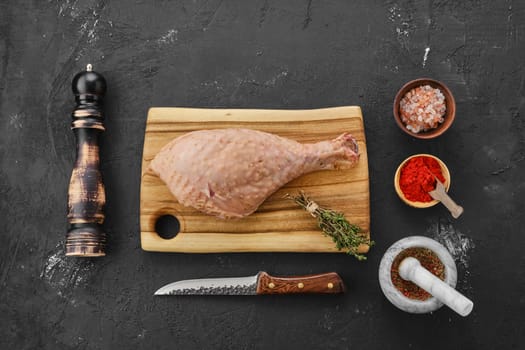 Top view of raw fresh turkey drumstick with spices
