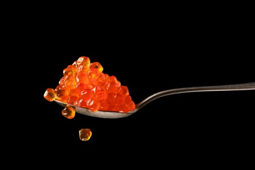 Spoon with salmon red caviar.