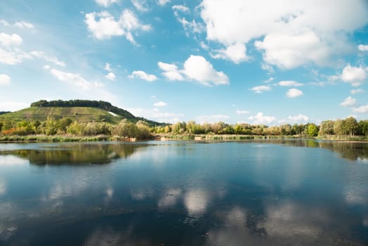Biodiversity Haff Reimech, wetland and nature reserve in Luxembourg, pond surrounded by reed and trees, bird watching observation point