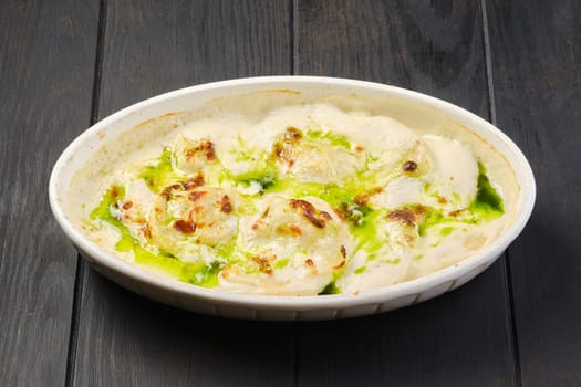 Pork dumplings with mushroom and onion sauce baked in oven