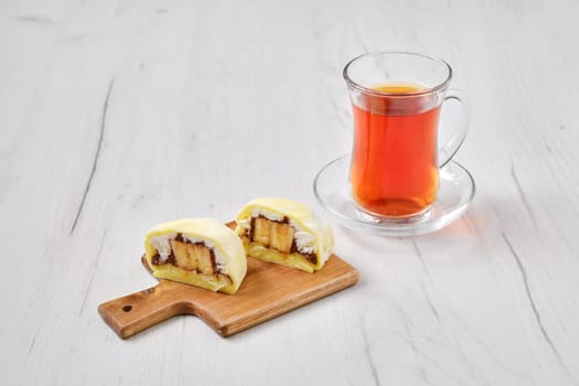Sweet dessert mochi cut on half with fruit tea