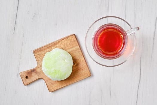 Top view of sweet dessert mochi with kiwi with fruit tea